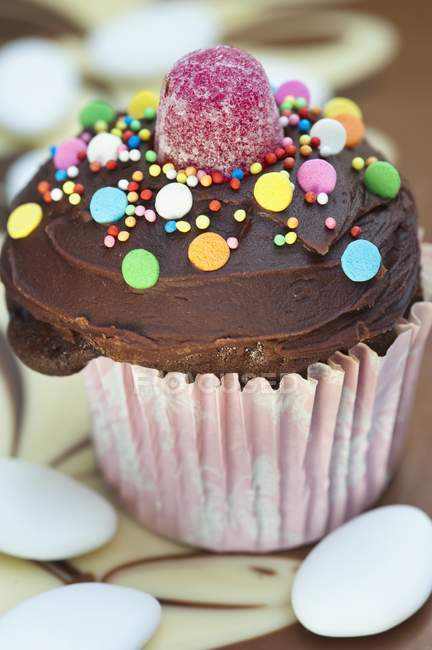 Cupcake decorated with colorful candies — Stock Photo