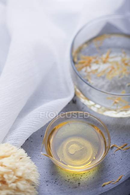 Closeup view of Marigold oil and sponge — Stock Photo