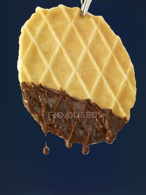 Waffled dipped in melted chocolate — Stock Photo