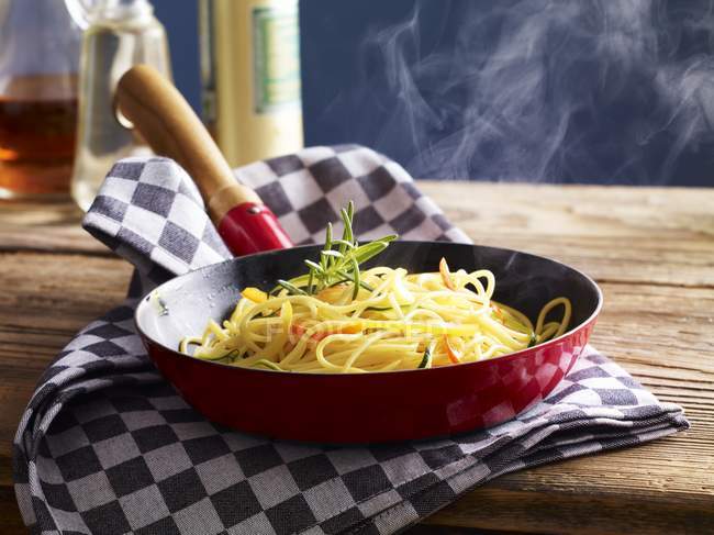 Spaghetti in pan with zucchini — Stock Photo