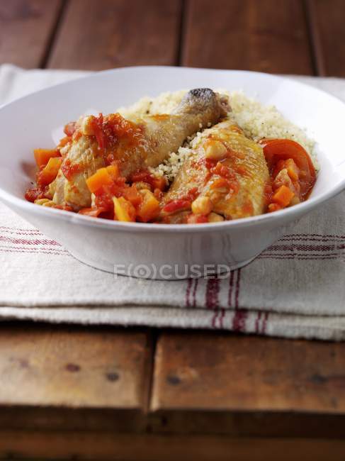 Chicken with couscous served in white bowl — Stock Photo