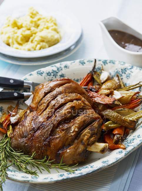 Roasted shoulder of lamb with vegetables — Stock Photo