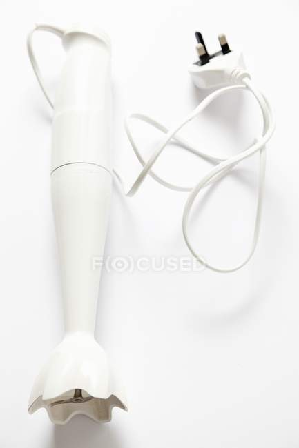Closeup view of a one hand blender on white surface — Stock Photo