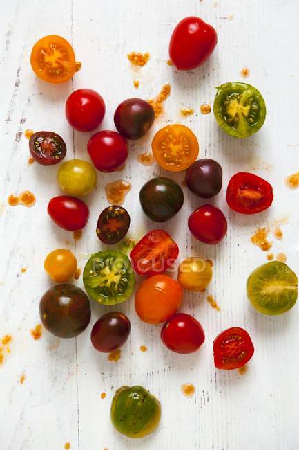 Tomatoes on white wooden board — Stock Photo