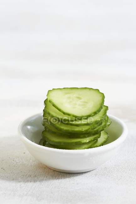 Cucumber slices in bowl — Stock Photo