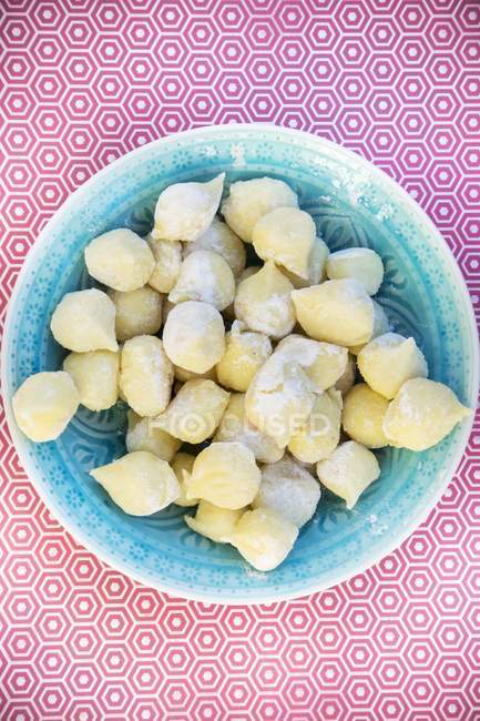 Top view of fresh Gnocchi in a blue bowl — Stock Photo
