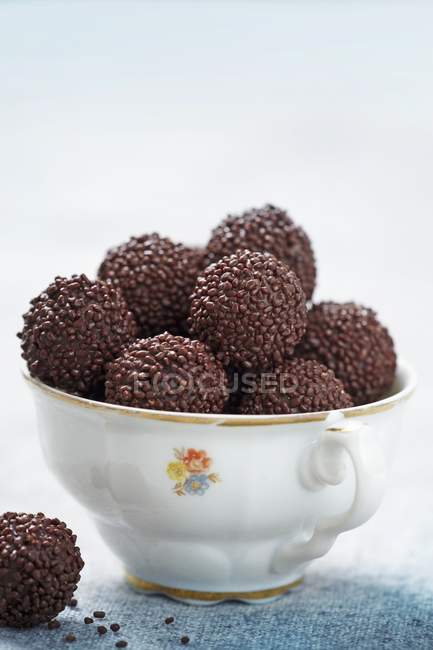 Chocolate truffles in cup — Stock Photo