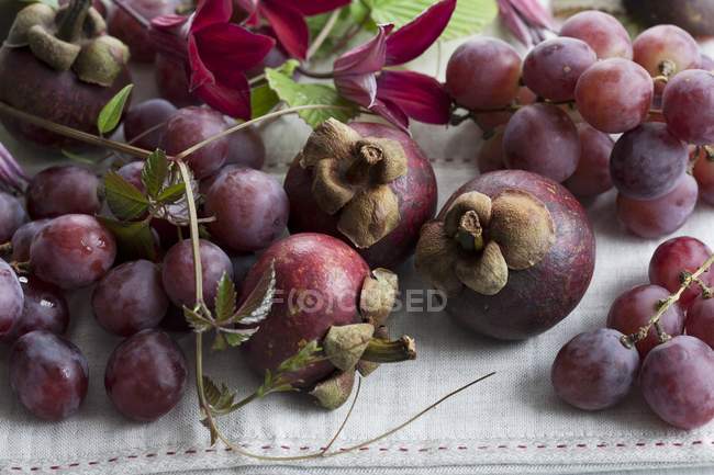 Fresh mangosteen fruits and grapes — Stock Photo