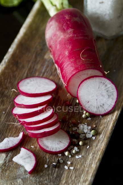 Red radish with salt and peppercorns — Stock Photo