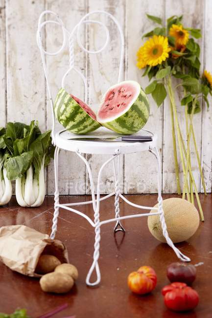 Cut watermelon on chair — Stock Photo