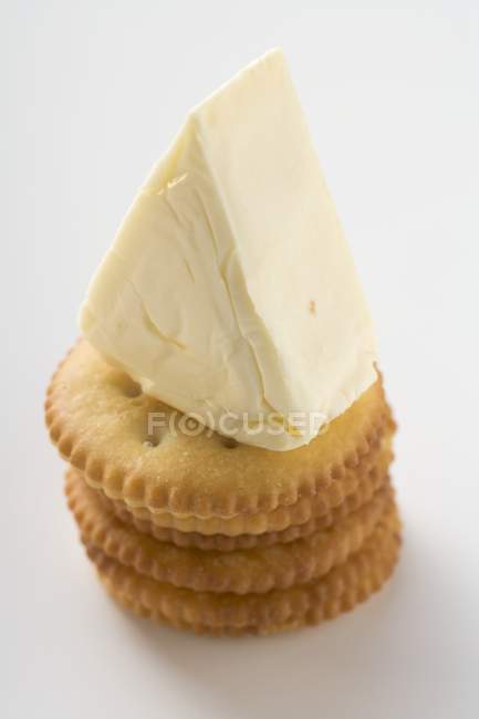 Processed cheese on crackers — Stock Photo
