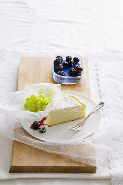 Rebanada de pastel de queso sobre escritorio de madera - foto de stock