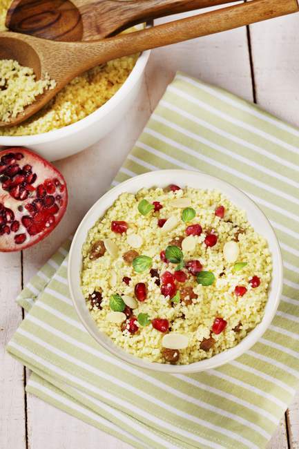 Couscous with raisins, almonds and pomegranate seeds — Stock Photo