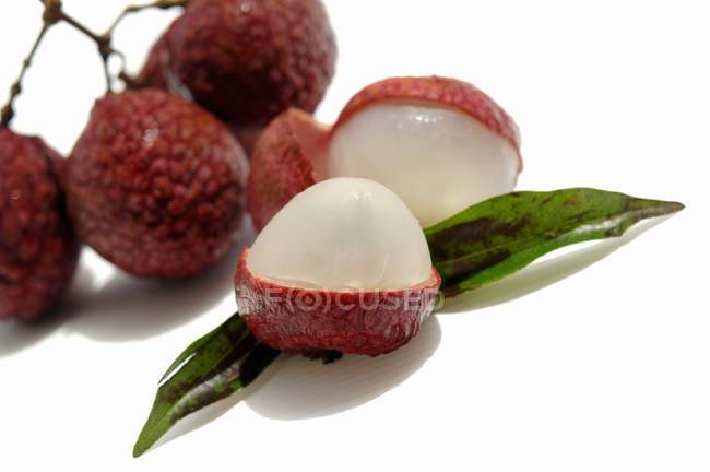 Fresh partly peeled lychees — Stock Photo