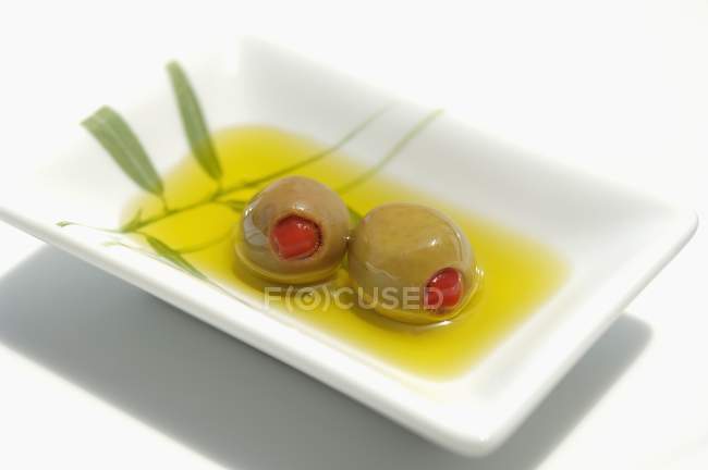 Stuffed olives in olive oil — Stock Photo