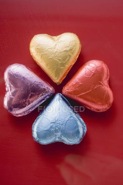 Heart-shaped chocolates in foil — Stock Photo