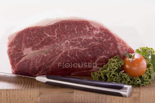 Fresh beef on wooden chopping board — Stock Photo