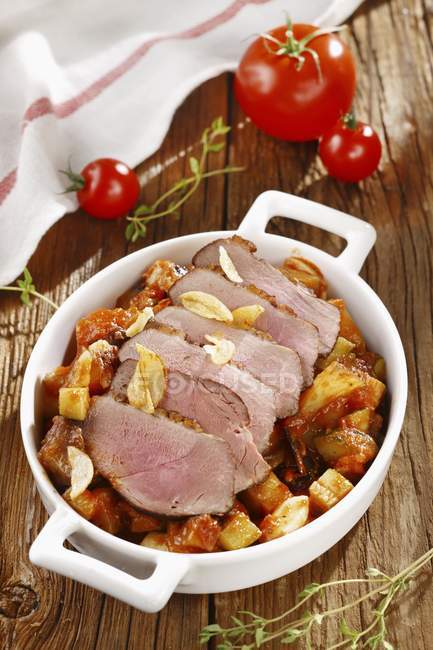 Roasted pork with vegetables and garlic — Stock Photo
