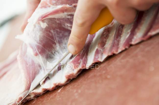 Butcher removing Lamb from bones — Stock Photo