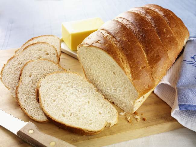 Partly sliced white loaf — Stock Photo