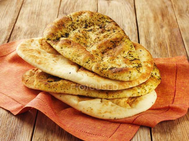 Naan breads with herbs — Stock Photo