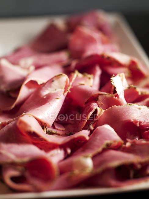 Platter of sliced ham — Stock Photo