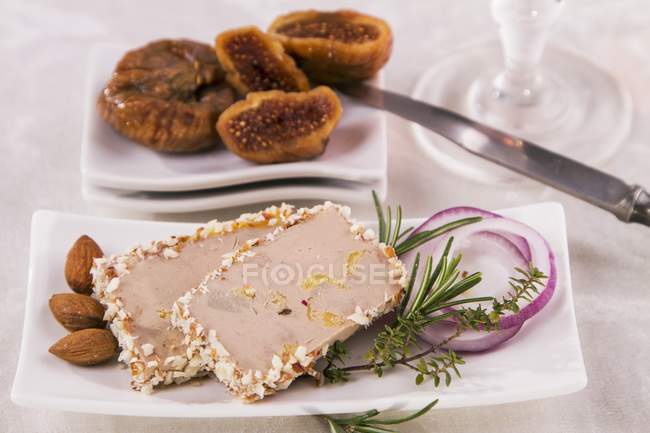 Closeup view of goose liver pate with almonds and figs — Stock Photo