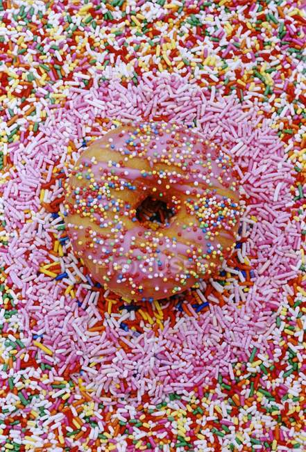 Doughnut with hundred and thousand sweets — Stock Photo