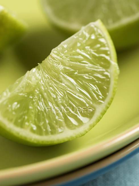 Fresh Lime wedge on plate — Stock Photo