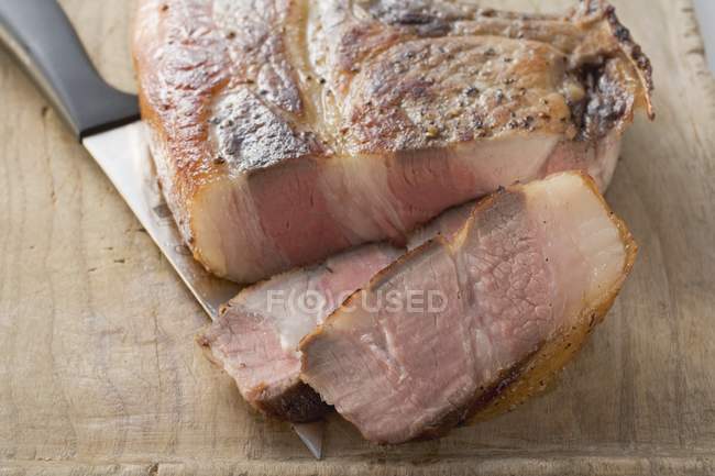 Partly sliced Fried pork chop — Stock Photo