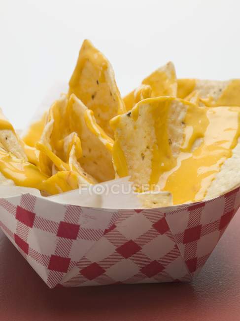 Nachos with cheese sauce — Stock Photo