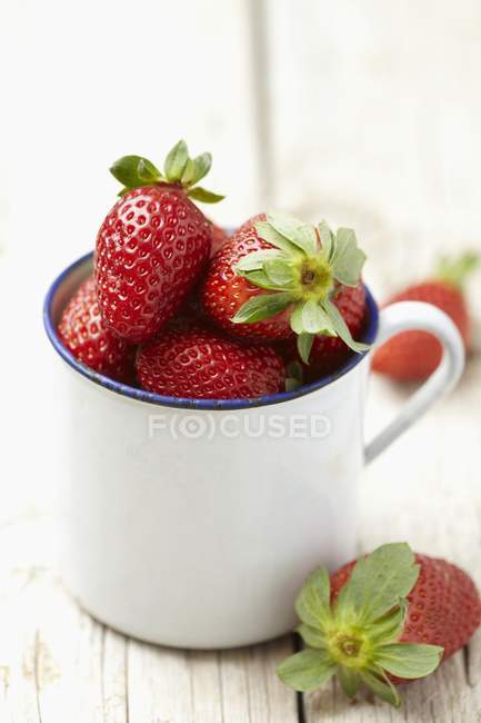 Strawberries in enamel cup — Stock Photo