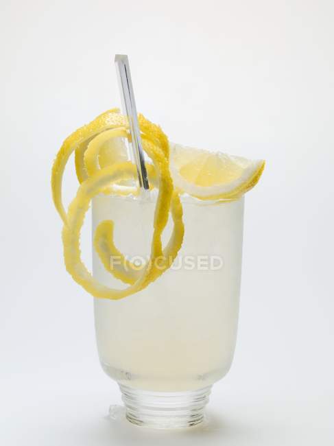 Glass of lemonade with lemons peel — Stock Photo
