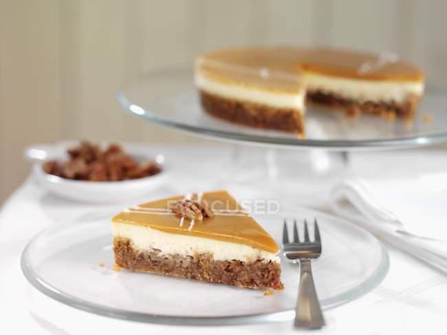 Cheesecake with pecans on stand — Stock Photo