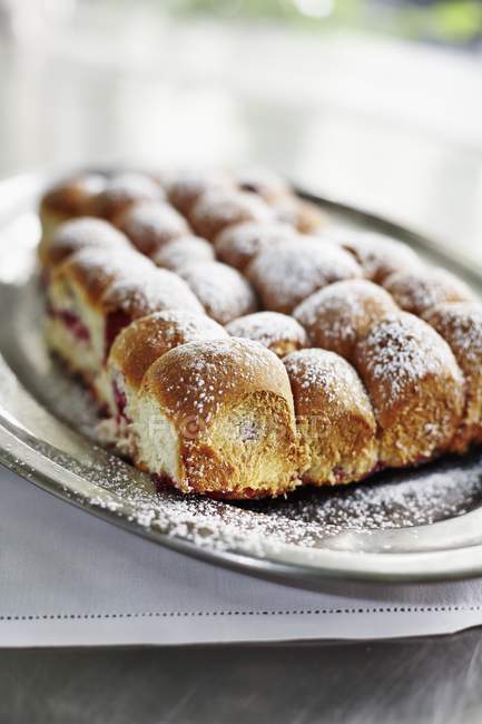 Closeup view of Damson filled Buchteln sweet yeast dumplings dusted with icing sugar — Stock Photo