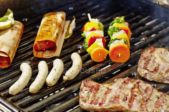 Sausages, kebabs and salmon — Stock Photo