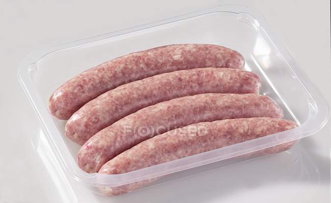 Sausages in plastic container — Stock Photo