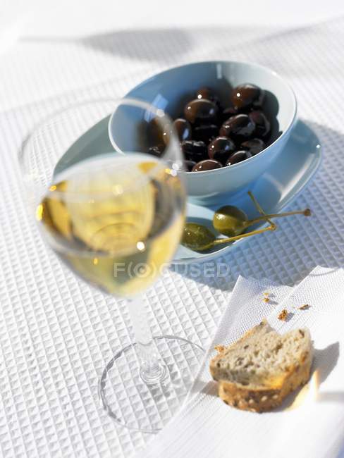 Glass of white wine on set table — Stock Photo