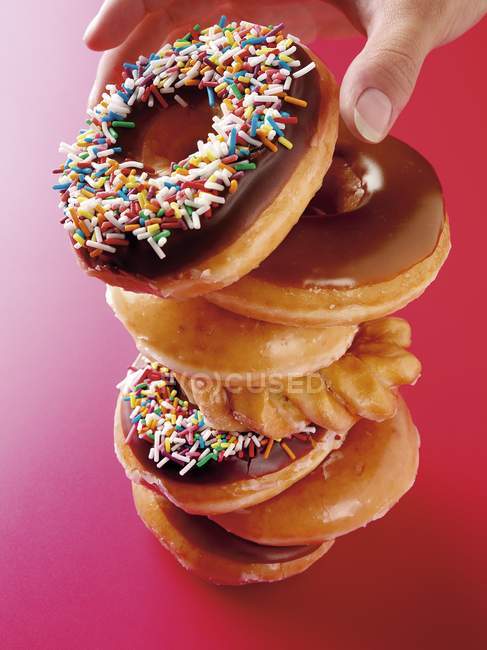 Stacked Doughnuts on red — Stock Photo
