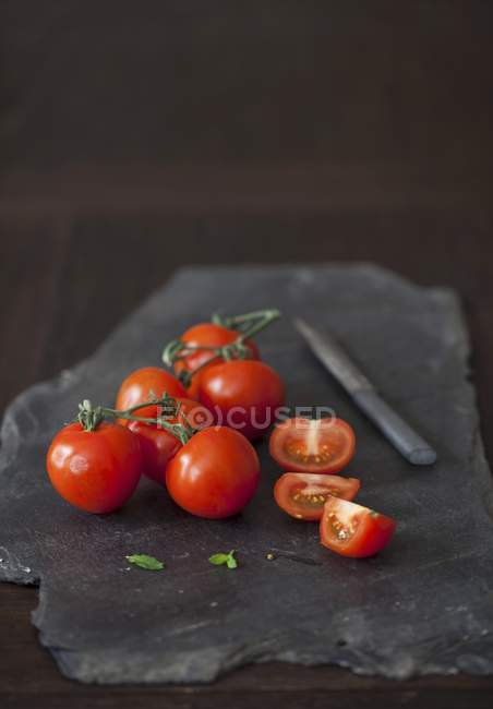 Tomatoes whole and halved — Stock Photo