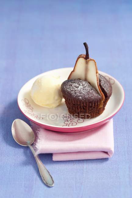 Chocolate muffin with slice of pear — Stock Photo