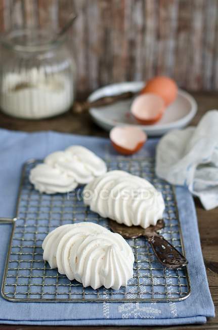 White meringues, eggshells and sugar — Stock Photo