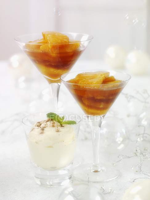 Closeup view of caramelized oranges and creme in glasses — Stock Photo