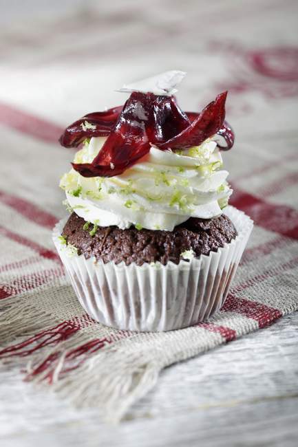 Chocolate cupcake topped with lime cream — Stock Photo