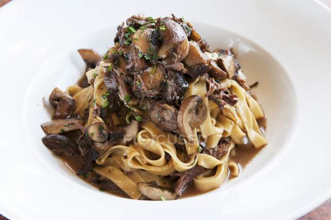 Tagliatelle pasta with wild mushrooms — Stock Photo