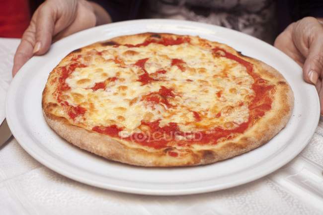 Human hands holding pizza Margherita — Stock Photo