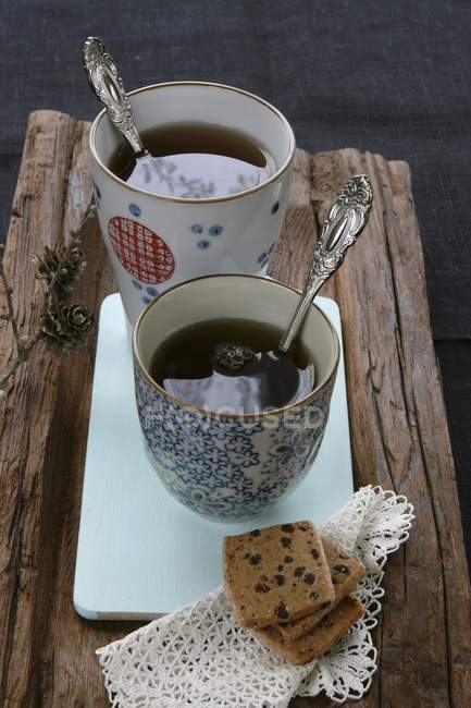 Shortcakes and doily on piece of wood — Stock Photo