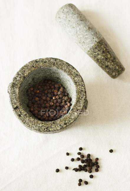 Dried Peppercorns in mortar — Stock Photo