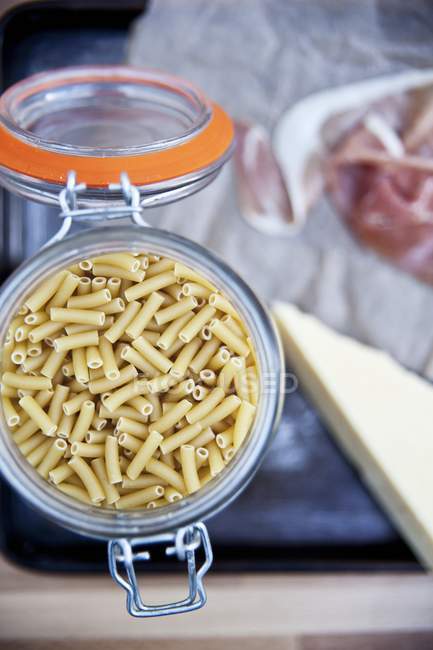 Jar of organic wheat pasta — Stock Photo