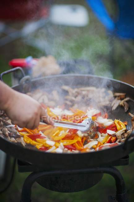 Onions and peppers being fried — Stock Photo
